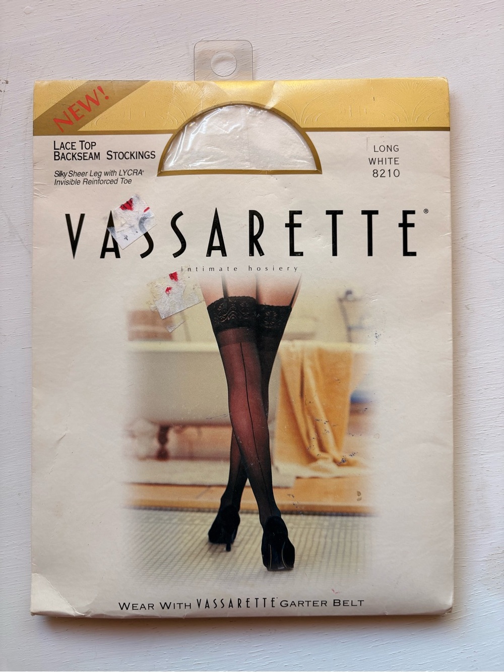 vassarette White & Gold Hosiery Packaging with Black Stocking Image